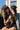 Woman wearing the Classic Cowboy Boone black and orange snapback while holding a black lab puppy.