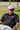 Man wearing the Classic Cowboy Brazos white and maroon snapback outdoors.