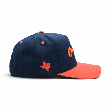Classic Cowboy The Wildcatter navy and coral snapback, side view of the coral Texas logo.