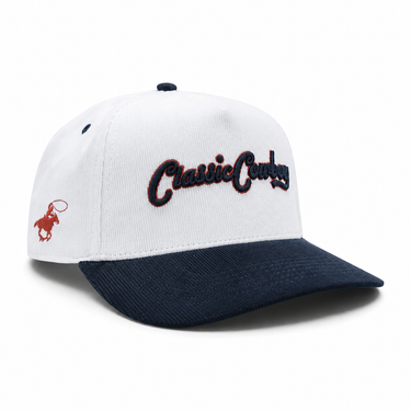 Classic Cowboy The Magnolia white and navy corduroy snapback with red cowboy side logo, angled view.