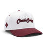 Classic Cowboy The Brazos white and maroon snapback with Texas side embroidery, angled view.