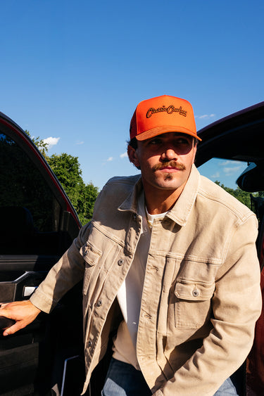Classic Cowboy The Setter red-orange suede brim snapback on display.