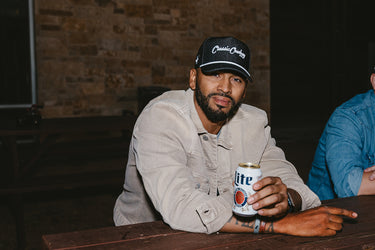 Classic Cowboy The Wingman black denim snapback hat worn, lifestyle photo.