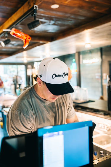 The Formal white and black corduroy snapback by Classic Cowboy, angled view.
