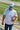 Man wearing the Classic Cowboy South Beach white and teal roper snapback at a football field.
