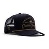 Classic Cowboy The Outpost all-black mesh back trucker hat with tonal gold embroidery and rope detail.
