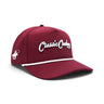 Classic Cowboy The Norman crimson roper snapback with white rope and cowboy side logo, angled view.