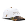 Classic Cowboy The Waylon white snapback with camo brim and tonal script embroidery, angled view.